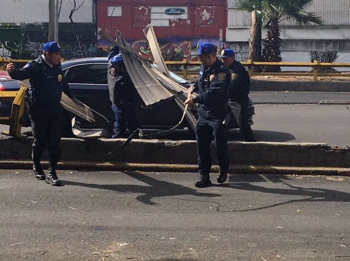 Policías apoyan el retiro del material del edificio ubicado sobre avenida Insurgentes. Foto: Vía Twitter @ZazilCarreras