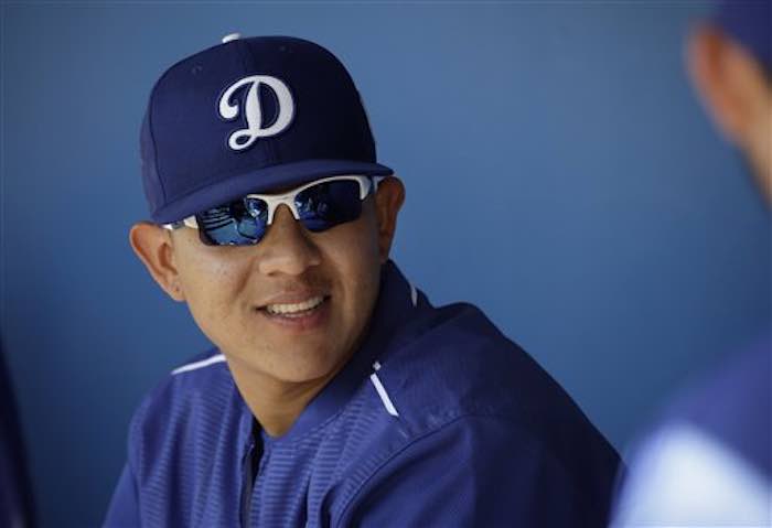 En la imagen, Urías conversa con compañeros de equipo en el dugout durante un juego de pretemporada ante Milwaukee.  Foto:  AP