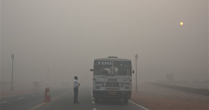 Un Policía De Tráfico De Delhi Habla Con Un Conductor De Autobús En Una Intersección En Medio Del Humo Y El Smog Foto Ap