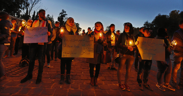 Xyb Damascus syrian Arab Republic Syrians Holding Posters Reading'we want peace.. we love peace' during a vigil at the Ummayyad Square in Damascus, Syria, on 30 December 2016. (Damasco, Siria) EFE/EPA/YOUSSEF BADAWI