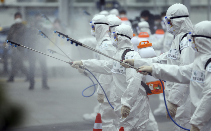 Soldados del ejército surcoreano, portando trajes protectores, rocían desinfectante para prevenir el contagio con el nuevo coronavirus en la estación de trenes de Dongdaegu en Daegu, Corea del Sur, el sábado 29 de febrero de 2020. Foto: Kim Hyun-tai/Yonhap vía AP