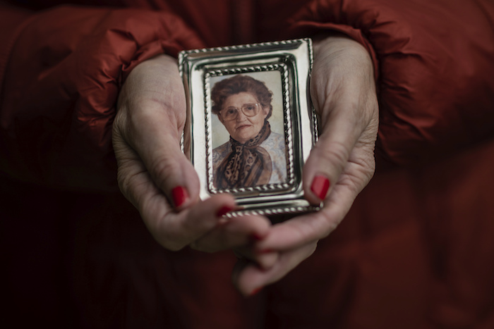 En esta imagen, tomada el 14 de mayo de 2020, Teresa Navarro muestra una fotografía de su madre, Concepción Rosinos, de 97 años, en Madrid, España.