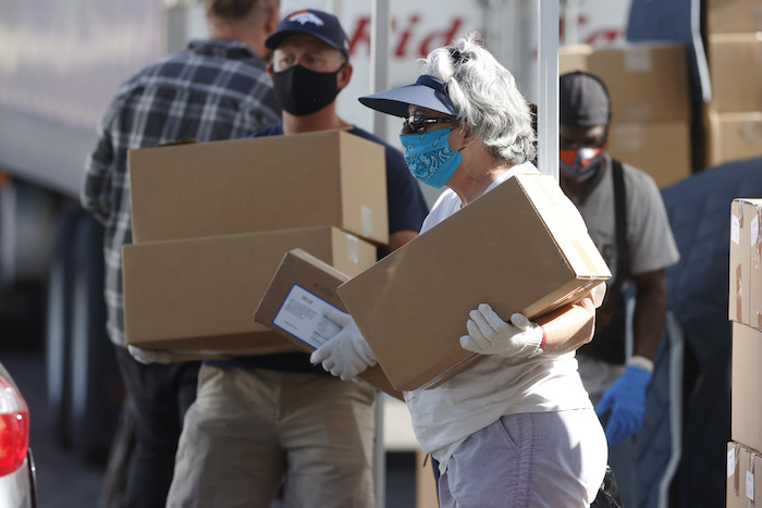 Foto tomada el 26 de junio del 2020 de personas ayudando a gente necesitada en Denver. 