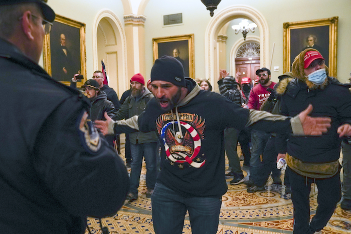 Simpatizantes del Presidente Donald Trump se enfrentan a la policía del Capitolio en el pasillo afuera del recinto del Senado, el miércoles 6 de enero de 2021, en Washington. 