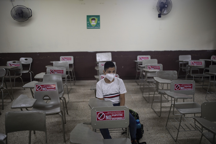 Un estudiante se sienta solo durante una clase presencial en la escuela pública José Azueta en Veracruz, México, el lunes 30 de agosto de 2021, mientras comienza un nuevo año académico durante la pandemia de COVID-19.