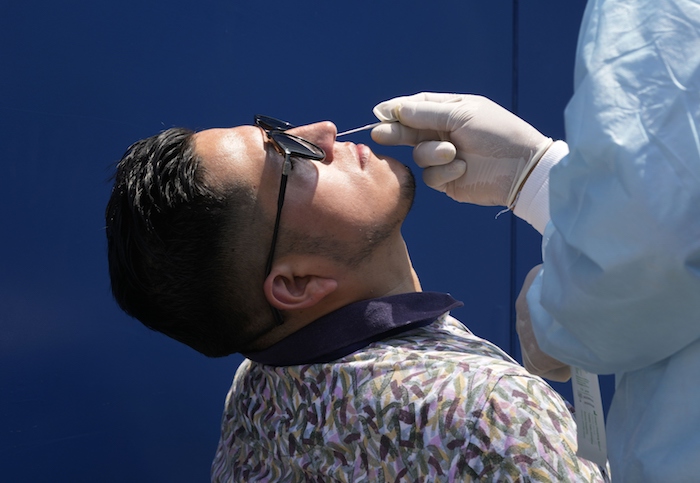 Un trabajador de salud toma una muestra para una prueba PCR para detectar COVID-19, el miércoles 5 de enero de 2022, en Lima.