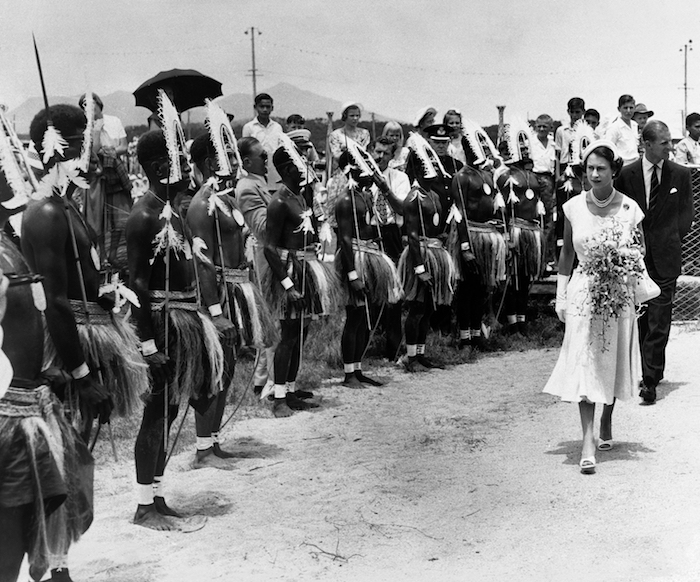 La reina Isabel II de Gran Bretaña y el príncipe Felipe inspeccionan a un grupo de habitantes isleños del Estrecho de Torres que hizo un baile tribal para la pareja real en una ceremonia de bienvenida en el Parque Parramatta en el pueblo de Cairns en Queensland, Australia, el 13 de marzo de 1954.