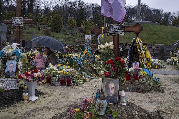 Tetiana Rurak, de 25 años, visita la tumba de su marido en el cementerio de Lychakiv en Leópolis, en el occidente de Ucrania, el martes 5 de abril de 2022, con su hija Oleksandra. Volodymyr Rurak era un soldado que murió en combate.