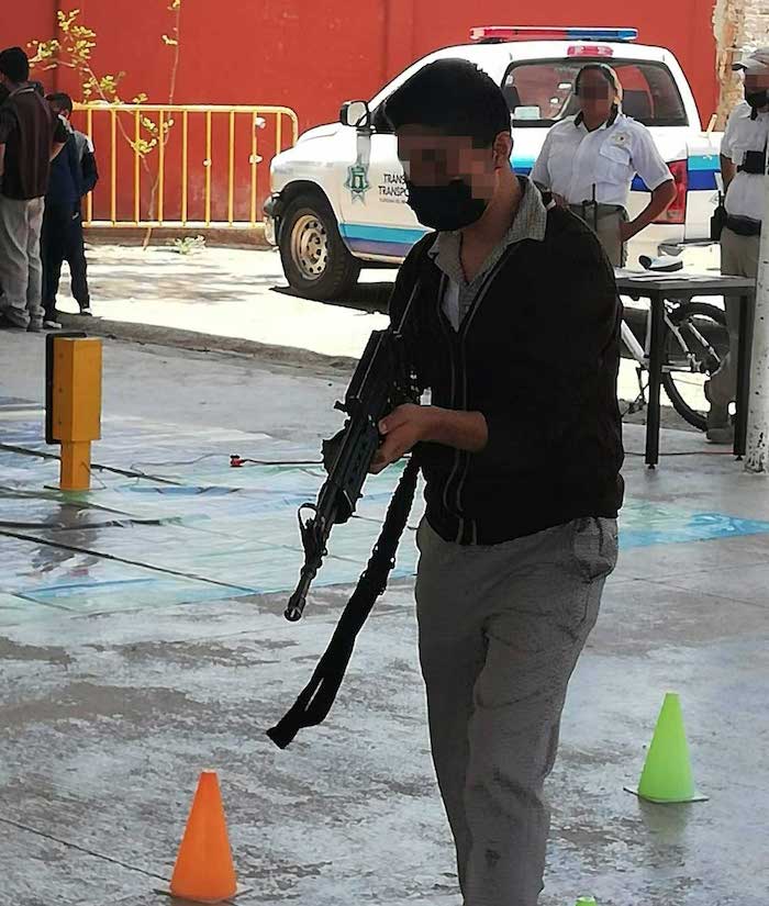 En otra imagen hay un adolescente que sostiene un arma larga, también en aparente indagación sobre cómo hacerla funcionar.