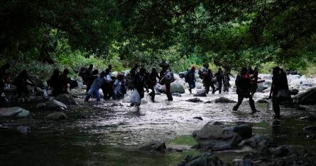 Migrantes cruzan el río Acandi en Acandi, Colombia, el 15 de septiembre de 2021, mientras continúan su viaje hacia el norte hacia la selva conocida como el Tapón del Darién.