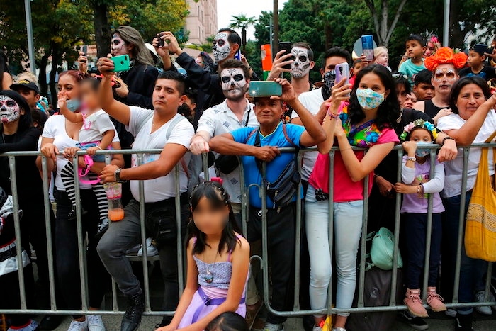 La gente observa el desfile del Día de Muertos en la Ciudad de México, el sábado 29 de octubre de 2022.