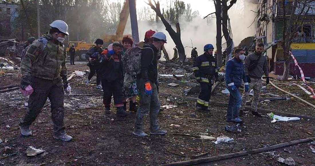 En esta imagen proporcionada por el servicio ucraniano de emergencias, rescatistas trabajan en el lugar de un ataque dañó edificios residenciales en Zaporiyia, Ucrania, el domingo 9 de octubre de 2022.