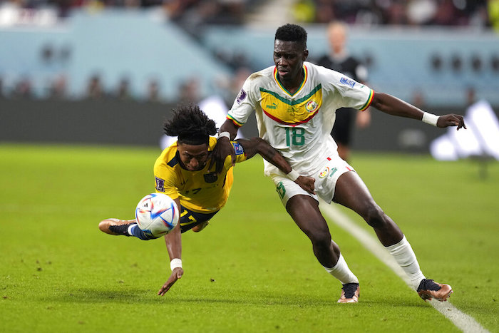 El ecuatoriano Angelo Preciado (izquierda) y el senegalés Ismaila Sarr pugnan por el balón durante el partido por el Grupo A del Mundial, el martes 29 de noviembre de 2022, en Doha, Qatar.