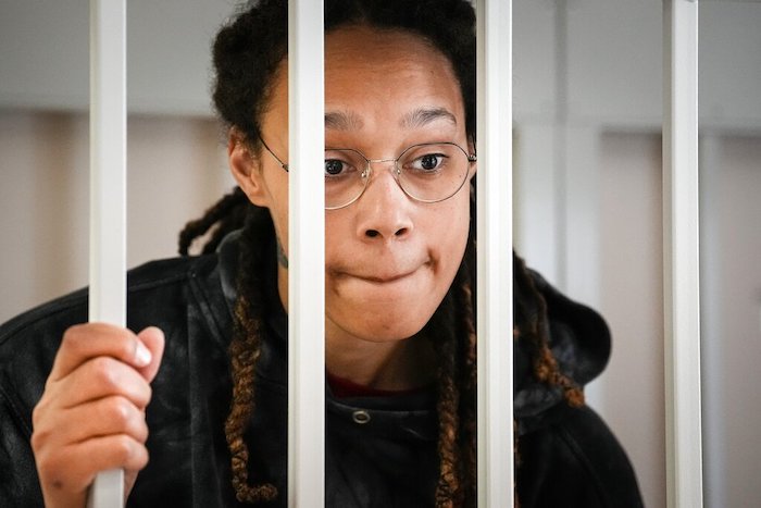 La jugadora de la WNBA y medallista de oro Brittney Griner habla con sus abogados en una jaula en una sala judicial en una vista en Khimki, a las afueras de Moscú, Rusia, el martes 26 de julio de 2022.