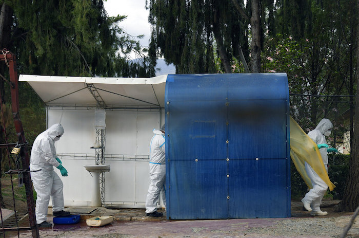 Trabajadores sanitarios, vestidos con equipos de protección, pasan por una cabina de desinfección antes de entrar a una granja de gallinas durante un brote de gripe aviar en Sacaba, Bolivia, el 31 de enero de 2023.