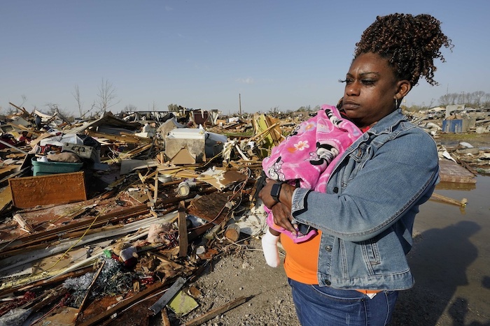 Wonder Bolden carga a su nieta de un año, Journey Bolden, junto a los restos de la casa rodante de su madre, demolida por un tornado, el sábado 25 de marzo de 2023, en Rolling Fork, Mississippi.