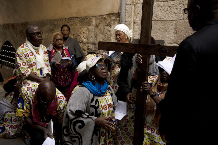 Un grupo de cristianos hace una pausa por la Vía Dolorosa, un trayecto que se cree fue por el que caminó Jesus rumbo a su crucifixión, el Viernes Santo en la Ciudad Antigua de Jerusalén, el viernes 7 de abril de 2023.