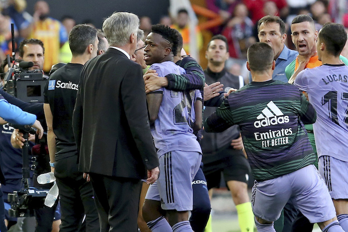 Vinícius Júnior (centro) del Real Madrid pasa al lado de su técnico Carlo Ancelotti tras ser expulsado del partido contra el Valencia en la Liga de España, el domingo 21 de mayo de 2023.