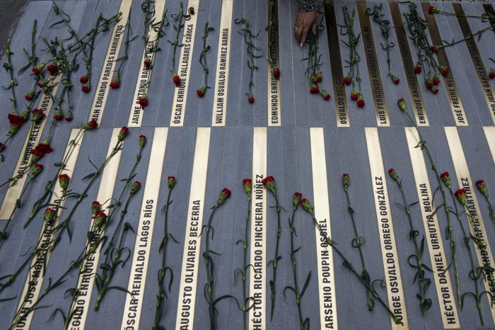 Flores adornan un monumento en la entrada este del palacio presidencial de La Moneda, durante una ceremonia de colocación de placas con los nombres de los trabajadores que estuvieron en el palacio durante el golpe militar del general Augusto Pinochet y que luego fueron ejecutados políticamente, detenidos o desaparecidos, en Santiago, Chile, lunes 4 de septiembre de 2023.