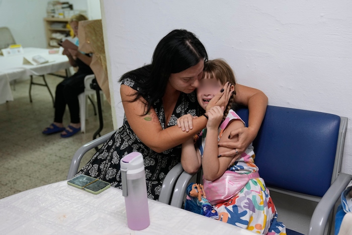 Israelíes se resguardan en un refugio mientras suena una sirena de advertencia de ataques con cohetes lanzados desde la Franja de Gaza, el martes 10 de octubre de 2023, en Ascalón, Israel. Hamás, el grupo islamista que gobierna la Franja de Gaza, llevó a cabo un ataque sin precedentes contra Israel el sábado, el cual dejó más de mil muertos y varios secuestrados. En respuesta, Israel lanzó intensos ataques aéreos contra el territorio, matando a cientos de palestinos