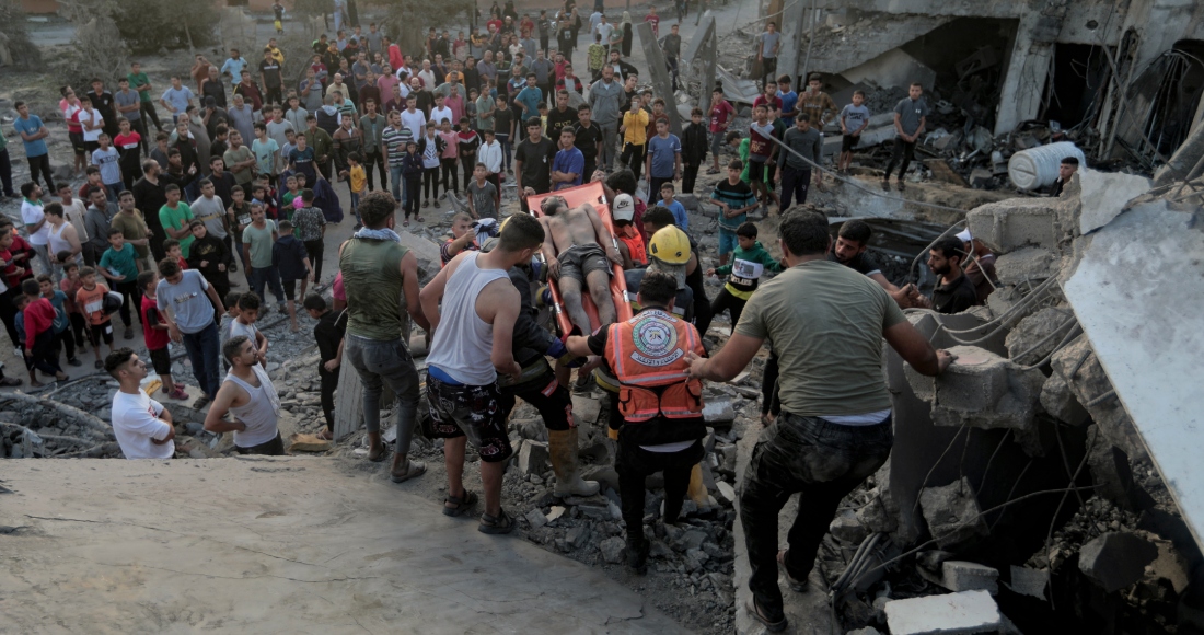 Palestinos evacúan a un sobreviviente de una casa destruida por un ataque aéreo israelí en la población de Khan Younis, en el sur de la Franja de Gaza, el martes 17 de octubre de 2023.