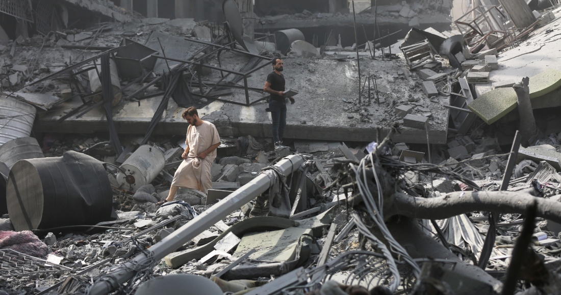 Palestinos inspeccionan los daños de edificios destruidos tras los ataques aéreos israelíes sobre Ciudad de Gaza, el lunes 23 de octubre de 2023.