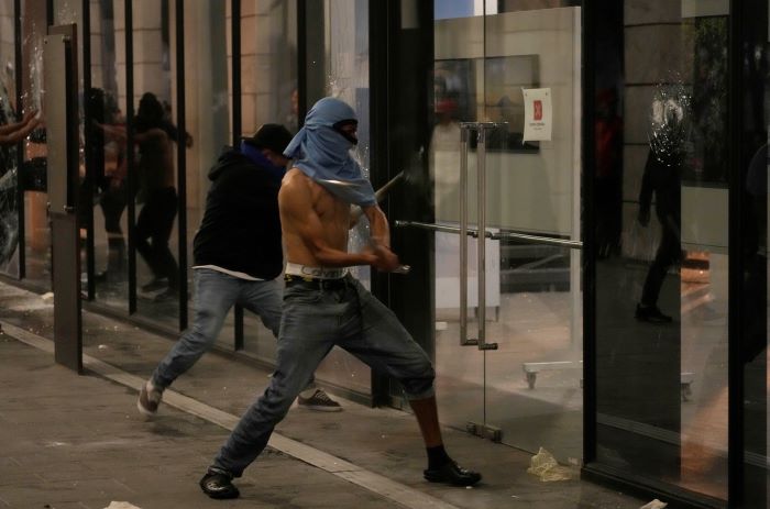 Manifestantes atacan un edificio en el centro de la Ciudad de Guatemala durante un paro nacional, el lunes 9 de octubre de 2023. 