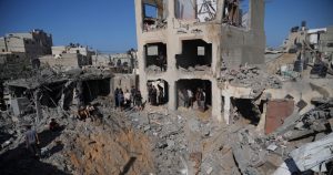 Palestinos observan un edificio destruido por un bombardeo israelí en Deir al Balah, en la Franja de Gaza.