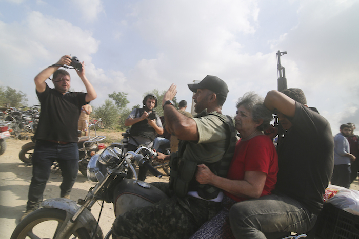 Palestinos llevan a una civil israelí capturada (centro) desde el kibutz de Kfar Azza a la Franja de Gaza, el 7 de octubre de 2023.