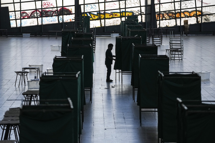 Un trabajador electoral prepara un centro cultural en la antigua estación de tren de Mapocho para que sea un colegio electoral durante el plebiscito constitucional en Santiago, Chile, el viernes 15 de diciembre de 2023.