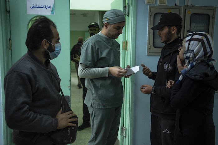 El médico Suhaib Alhamss, director del Hospital Kuwaití en Rafah, la ciudad más sureña de la Franja de Gaza, habla con pacientes afuera del departamento administrativo del nosocomio, el jueves 11 de enero de 2024.