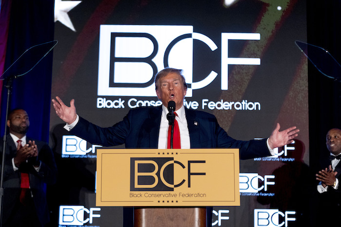 El precandidato presidencial republicano, el expresidente Donald Trump, acompañado por el representante Byron Donalds, republicano de Florida, a la izquierda, y el representante Wesley Hunt, republicano de Texas, a la derecha, habla en la Gala Anual de Honores BCF de la Federación Conservadora en el Centro de Convenciones Metropolitano de Columbia en Columbia, Carolina del Sur, el viernes 23 de febrero de 2024.