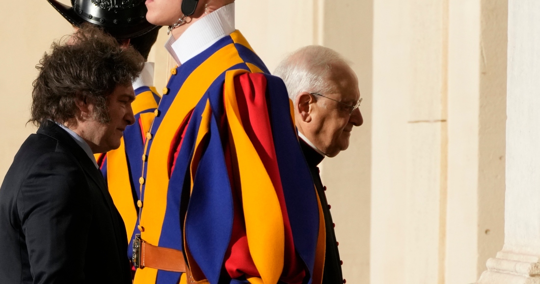 El Presidente argentino Javier Milei, a la izquierda, se ve precedido por el jefe de la casa papal, el obispo Leonardo Sapienza, a la derecha, entre dos guardias suizos en el Patio de San Dámaso en el Vaticano, a su llegada para una audiencia con el Papa Francisco, el lunes 12 de febrero de 2024.