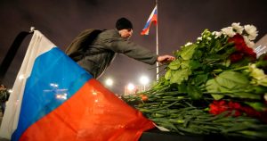 Un hombre coloca flores en un altar improvisado a las víctimas del ataque en Moscú, en San Petersburgo, Rusia, el sábado 23 de marzo de 2024.