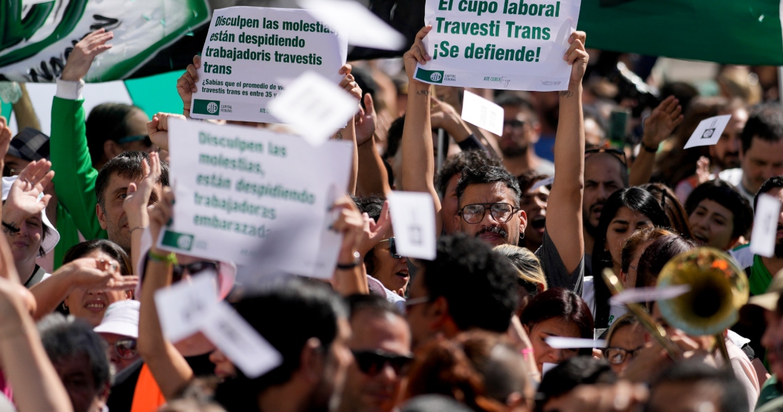 Ariel Heredia, que se identifica como no binarie, muestra un cartel a favor del cupo laboral trans en una manifestación que reclama la reincorporación de empleados públicos despedidos, a las afueras del Ministerio de Economía en Buenos Aires, Argentina, el viernes 5 de abril de 2024. Heredia sufrió un despido luego del desmantelado Ministerio de las Mujeres, como parte de las medidas de austeridad del Gobierno del Presidente ultraliberal Javier Milei.