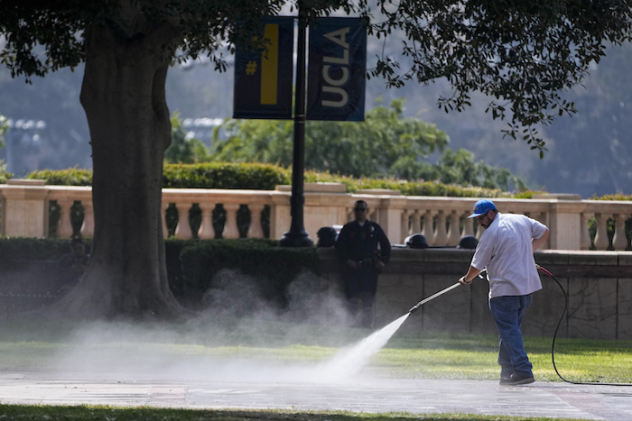 Un hombre limpia el suelo luego de que la policía retiró un campamento de protesta propalestino en el campus de la Universidad de California en Los Ángeles, el jueves 2 de mayo de 2024.