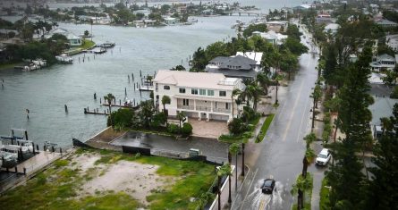 Un conductor pasa por una calle inundada mientras la tormenta tropical Debby pasa al oeste de Tampa Bay, Florida, el domingo 4 de agosto de 2024.