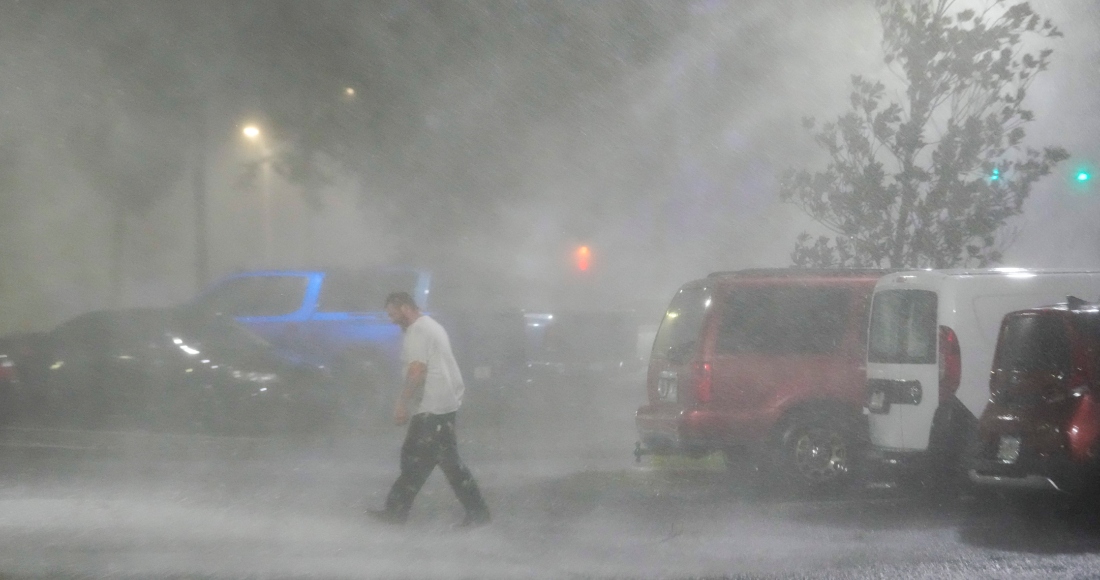 Max Watts, de Buford, Georgia, camina por un estacionamiento para revisar un tráiler estacionado en el exterior del hotel donde espera el paso del huracán Milton con otros compañeros, el 9 de octubre de 2024, en Tampa, Florida. 