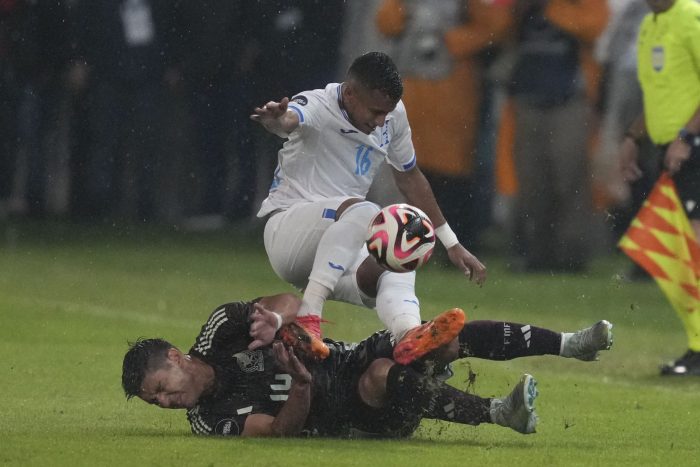 El mexicano Jesús Angulo, abajo, y el hondureño Edwin Rodríguez disputan una pelota en el partido por la Liga de Naciones de la Concacaf en el estadio Francisco Morazán en San Pedro Sula, Honduras, el viernes 15 de noviembre de 2024.