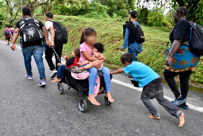 Varios niños montados en un carrito por la carretera de Huixtla.